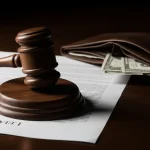 A gavel and legal document on a desk representing a CPS case, with an open wallet nearby to symbolize the lawyer costs involved.